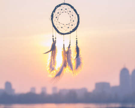 Dream catcher against the sky. City across the river. Far from the bustle of the city. Horizontal...