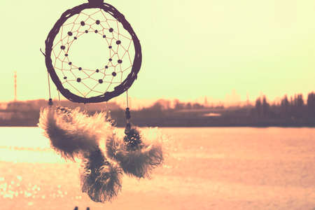 Dream catcher against the sky. City across the river. Far from the bustle of the city. Horizontal photography.の写真素材