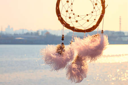 Dream catcher against the sky. City across the river. Far from the bustle of the city. Horizontal photography.の写真素材