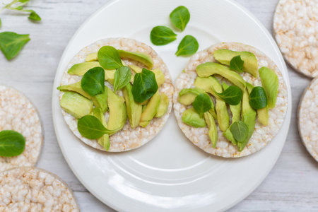 Crispy rice cakes with sliced avocado. Healthy and fresh breakfast. Healthy and vegan concept. Quick...