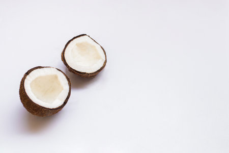 Pieces of coconut on white background, top view. Food and nature background.
