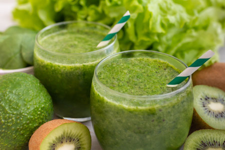 Healthy dieting and nutrition, vegan, vegetarian concept, healthy lifestyle. Green smoothie with organic ingredients, vegetables on a wooden table.の写真素材