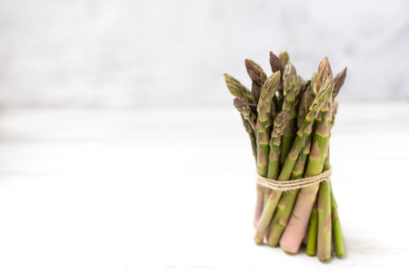 Bunch of fresh asparagus on wooden table. Healthy menu concept. Diet food.の写真素材