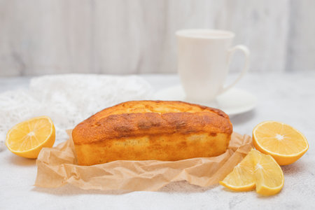 Lemon bread, cake with citrus, whole loaf. White background, copy space. Homemade cake.の写真素材