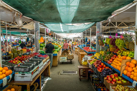 The fruits and vegetables like oranges, apples, bananas, cucumbers at the stalls of Maykop farmer's...