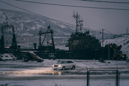 The abandoned rusty ship ashore the Okhotsk sea coast in Magadan during the cold winter night in Russia.の写真素材