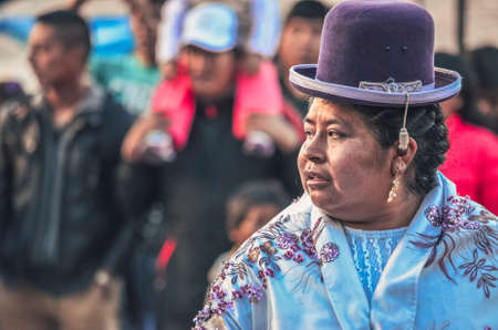 Colorful traditional dressed peruvian woman portrait during Christian celebration of the saint San...