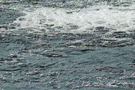 Turbulent River Water With River Foam - River Taff, Cardiff, Walesの写真素材