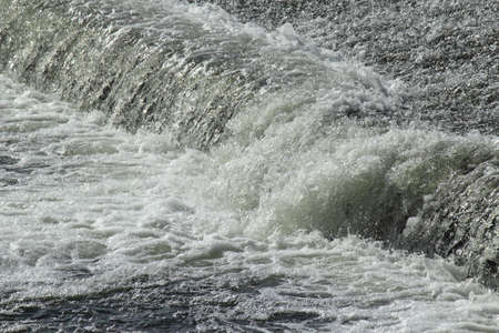 River Floweing Over a Weir - River Taff, Cardiff, Walesの写真素材