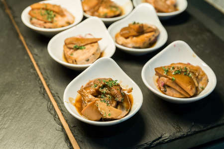 Roasted duck breast with baby carrot and orange sauce on hot stoneの写真素材