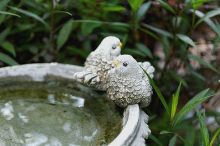 statue of couple of bird doll decoration in a gardenの写真素材