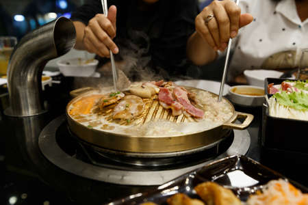 Pork grill on BBQ brass pan.の写真素材