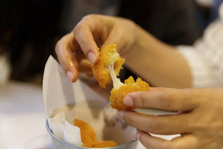 Enjoy to pulling the sticky fried Cheese Ball (focus selective)
