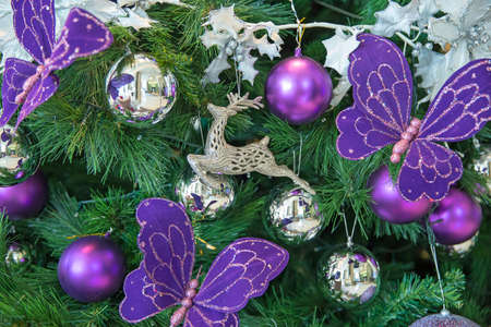 Beautiful decorated Christmas tree theme silver and purple on blurred, sparkling background