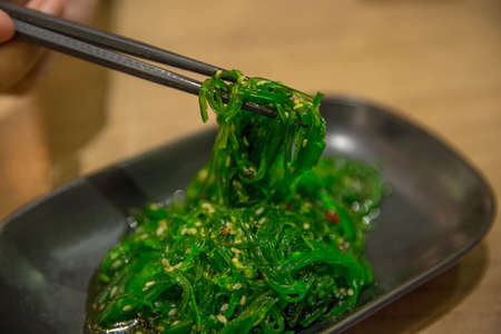 Seaweed with White Sesame, Japanese food in black plateの写真素材