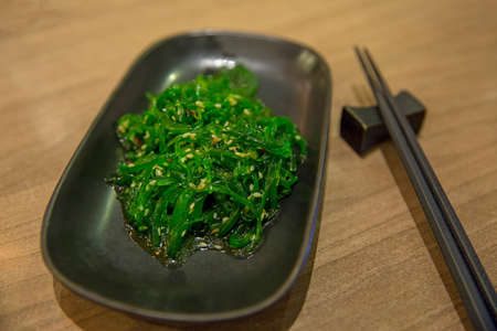 Seaweed with White Sesame, Japanese food in black plateの写真素材