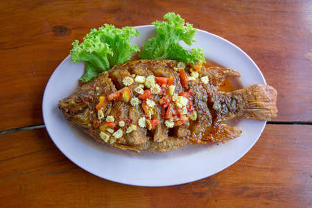 Ruby fish fried topping with lettuce and chilli sweet sauce