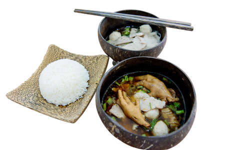Thai food,chicken foot soup and meat ball with rice serve in Coconut shell