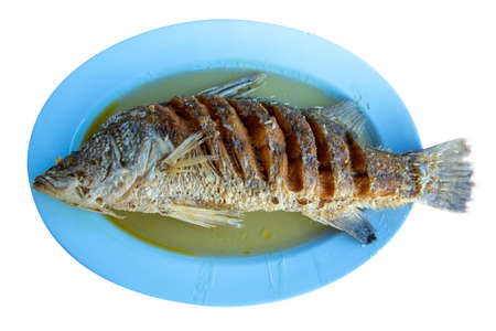 Fried snapper fish pour with fish sauce, die cut on white background