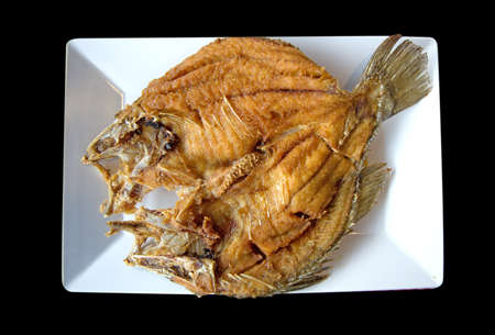 Fried snapper fish ,top view in black isolated