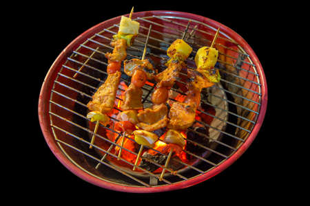 Party barbecues Skewer with pork on the stove, Die cut in black background