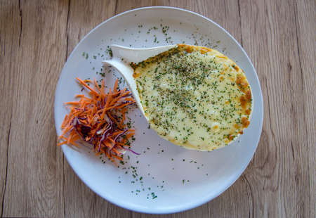 Top view of Baked mased Potato cheese with carrots on wooden background, focus selectiveの写真素材