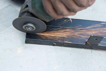 Close-up of worker cutting steel with grinder, focus selective.の写真素材