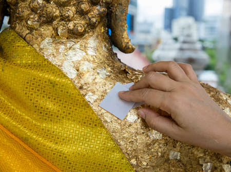 Gold foil at backside of religious icon in Thailand temple.