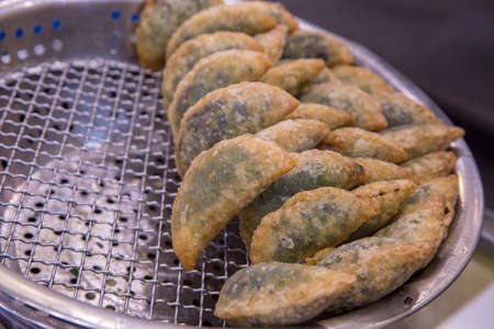 Chives dumpling(kuicheai) with oil in a pan at the local market