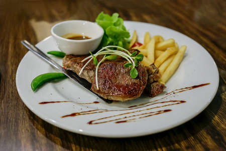 Grilled steak with french fries and vegetables