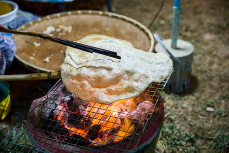 Giant rice crispy is a popular snack in North-eastern of Thailand. Cooking giant rice crispy.