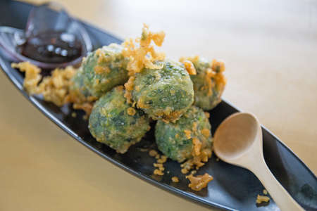 Fried Garlic Chive Dumplings, Steamed dumpling stuffed and garlic chives with wooden spoon, focus...