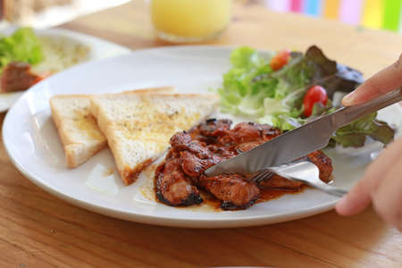 Pork steak and toast with knife, focus selectiveの写真素材