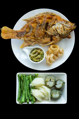 Die cut of fried Red Tilapia Fish and Northern Thai Green Chilli Dip mix with blanched vegetables,...