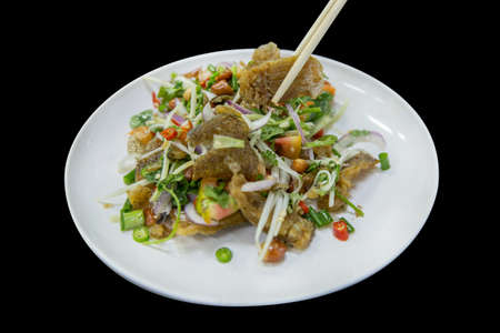 Top view of Salad Crispy Gourami Fish with Spicy Seafood Sauce, focus selective