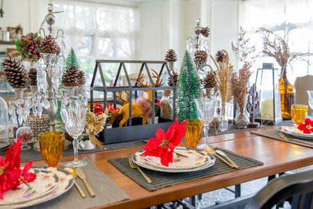 Christmas dinner table setup with decoration, focus selective.