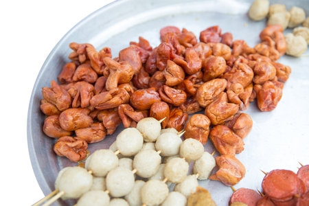 Die cut of fish ball are fried in boiled oil with aluminum pan on white isolated.の写真素材