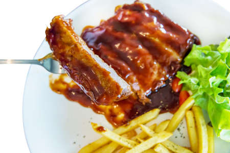 Die cut of Barbecue Pork Ribs with french fries on white isolated.の写真素材