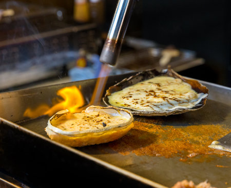 Cheese Scallop burned with gas on stove, street food.の写真素材