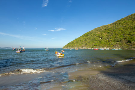 Aownoi Bay, THAILAND - December 31, 2023: Fishing boats moored at the pier in Aownoi Bay Prachuap Khiri Khan Province, with beautiful mountains and sky.の写真素材
