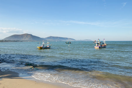 Aownoi Bay, THAILAND - December 31, 2023: Fishing boats moored at the pier in Aownoi Bay Prachuap Khiri Khan Province, with beautiful mountains and sky.の写真素材