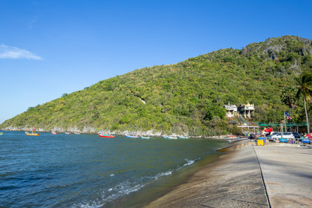Aownoi Bay, THAILAND - December 31, 2023: Fishing boats moored at the pier in Aownoi Bay Prachuap Khiri Khan Province, with beautiful mountains and sky.の写真素材