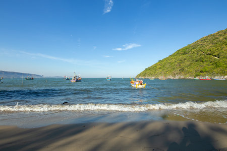 Aownoi Bay, THAILAND - December 31, 2023: Fishing boats moored at the pier in Aownoi Bay Prachuap Khiri Khan Province, with beautiful mountains and sky.の写真素材