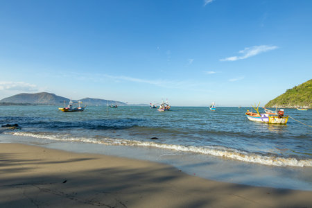 Aownoi Bay, THAILAND - December 31, 2023: Fishing boats moored at the pier in Aownoi Bay Prachuap Khiri Khan Province, with beautiful mountains and sky.のeditorial素材