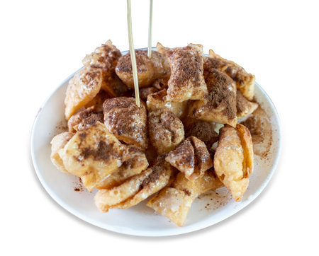 Die cut of roti topped with coco powder and condensed milk on white isolated.の写真素材