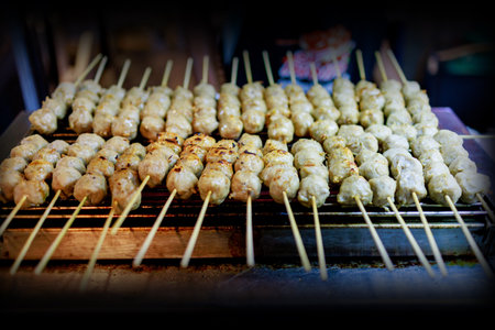 Die cut of Pork meatballs grill on a charcoal stove on white isolated.の写真素材