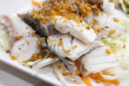 Die cut of Steam Red Snapper fillet with seafood spicy dipping on white isolated.