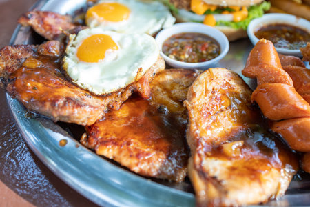 fried egg burger mix steak and sausage with sauceの写真素材