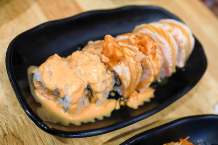 Die cut of sushi roll salmon with mustard sauceの写真素材
