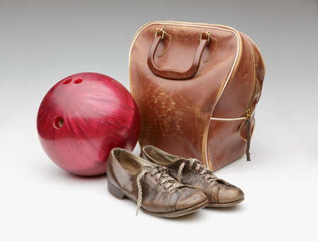 Vintage Red Bowling Ball, Weathered Leather Bag and Brown Shoes Isolated on Whiteの写真素材